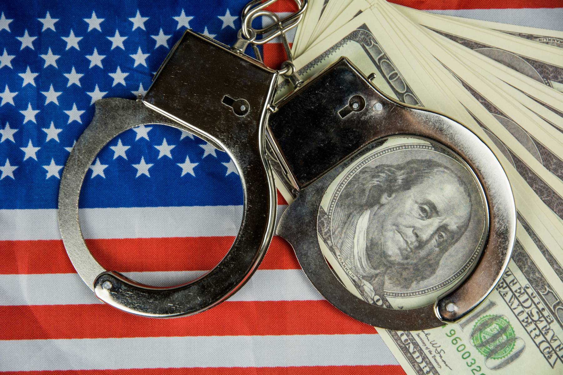USA flag-cash-handcuffs